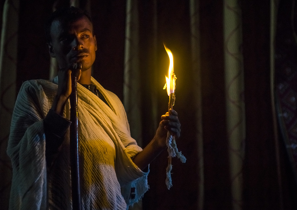 Priest Holding A Candle Inside A Rock Church, Lalibela, Ethiopia